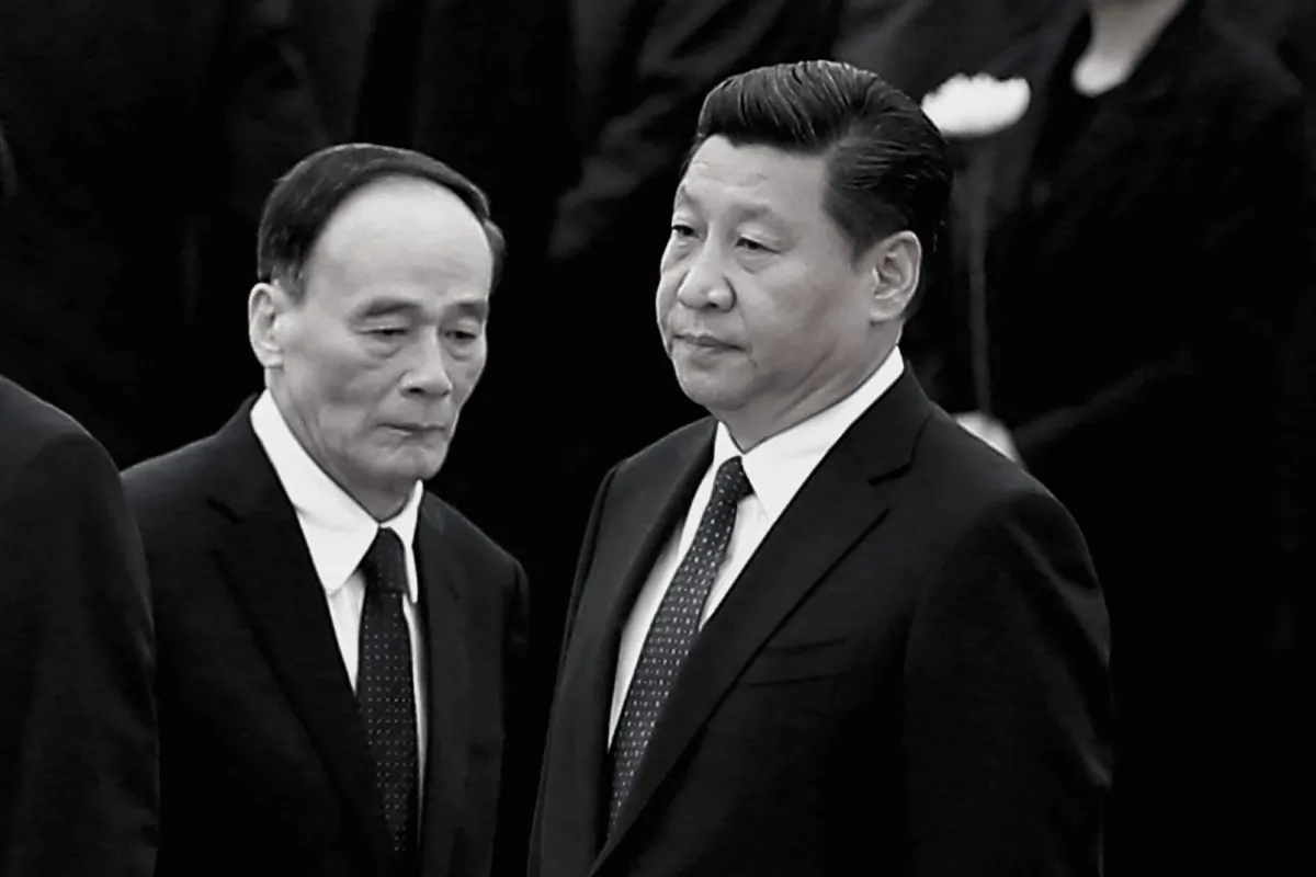 Chinese leader Xi Jinping (R) and former anti-corruption chief Wang Qishan in Beijing on Sept. 30, 2014. (Feng Li/Getty Images)