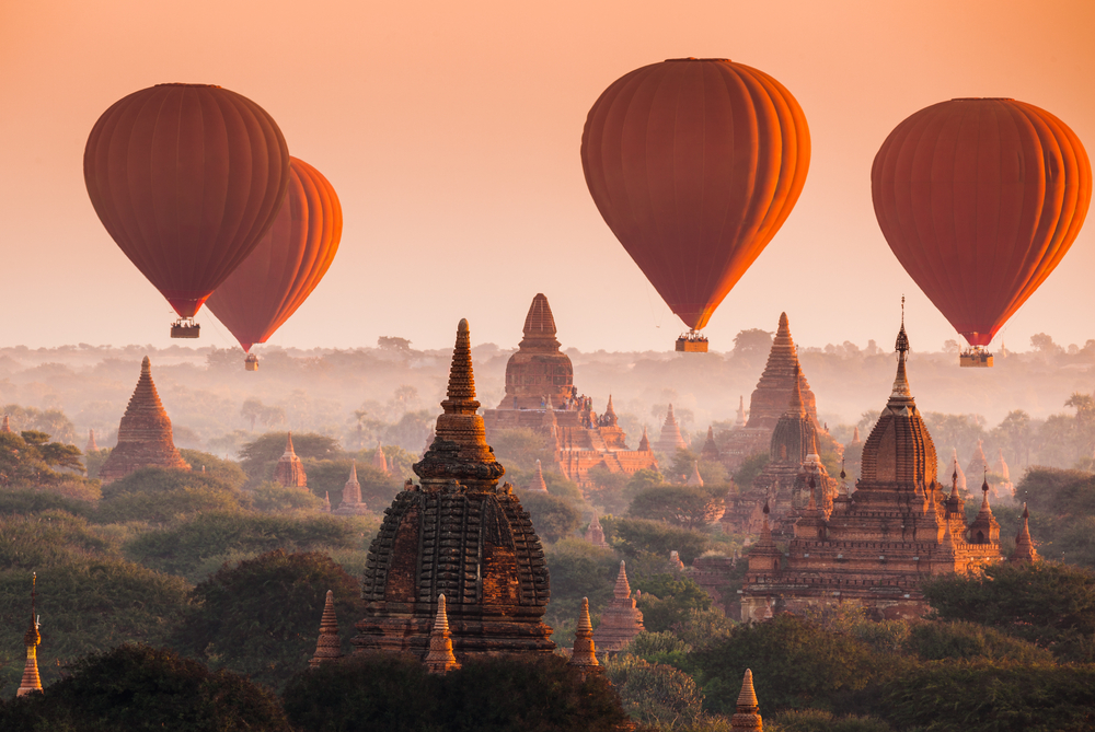 Hot air balloon over plain of Bagan in misty morning, Myanmar via Shutterstock*