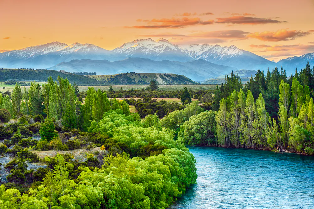 Sunset over the bend of the river Clutha with Southern Alps peaks on the horizon, New Zealand via Shutterstock*