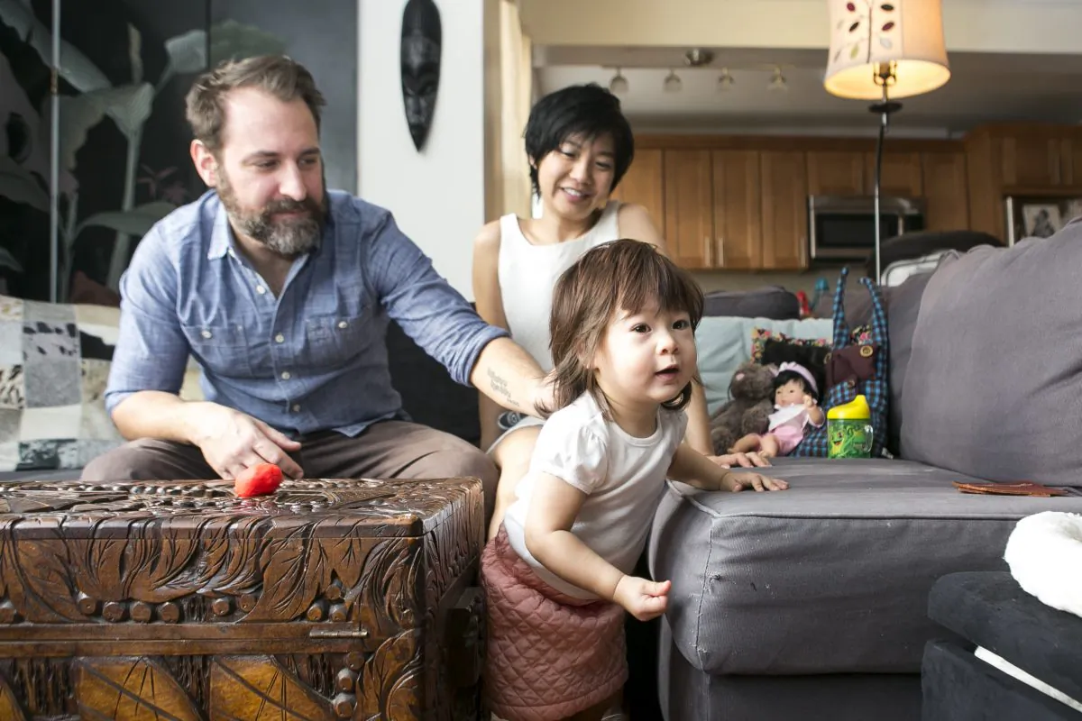Musician Jeremy Wilms, his wife, actress Di Quon Wilms, and their 21-month-old daughter at their home in Forest Hills, Queens, on Thursday, Jan. 22, 2015. The former Brooklynites took their house hunting to three other states before resuming their search in New York City. (Samira Bouaou/Epoch Times)
