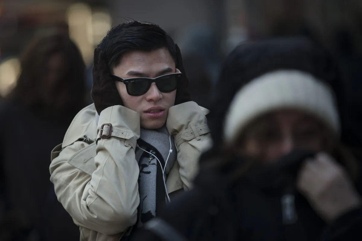 Pedestrians brave the cold during their morning commute, Friday, Feb. 20, 2015, in New York. Arctic air and bitterly cold wind is moving across the Northeast, plunging temperatures into record low single digits, accompanied by subzero wind chills. (AP Photo/John Minchillo)