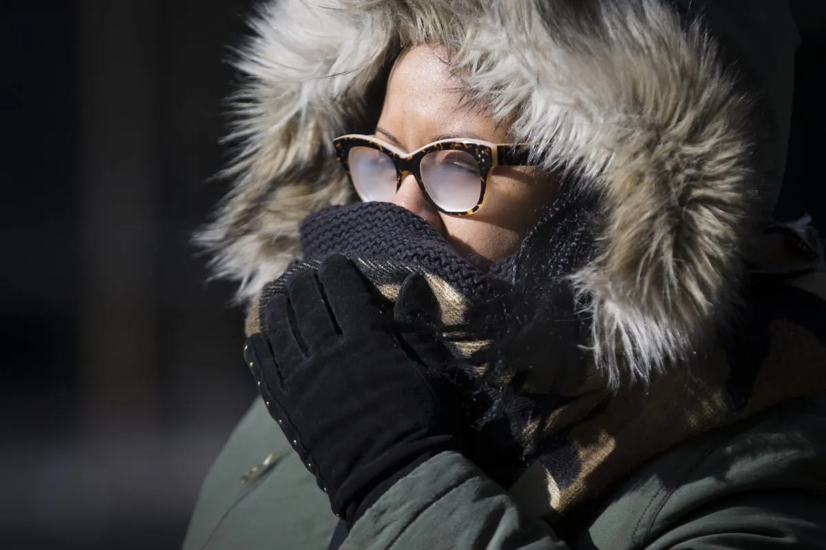 Pedestrians brave the cold during their morning commute, Friday, Feb. 20, 2015, in New York. Arctic air and bitterly cold wind is moving across the Northeast, plunging temperatures into record low single digits, accompanied by subzero wind chills. (AP Photo/John Minchillo)