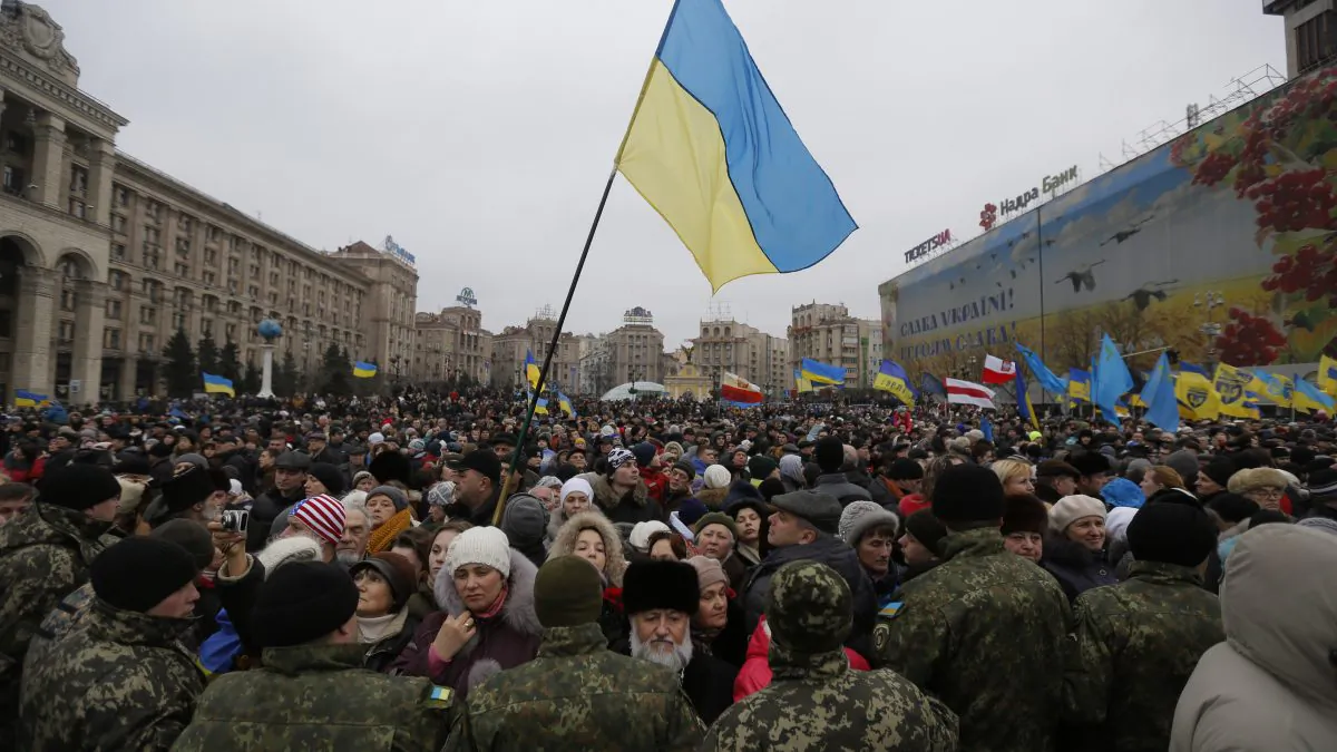 Thousands march in Kyiv on Sunday commemorating the events of a year ago and honoring over 100 protesters who died. (AP Photo/Sergei Chuzavkov)
