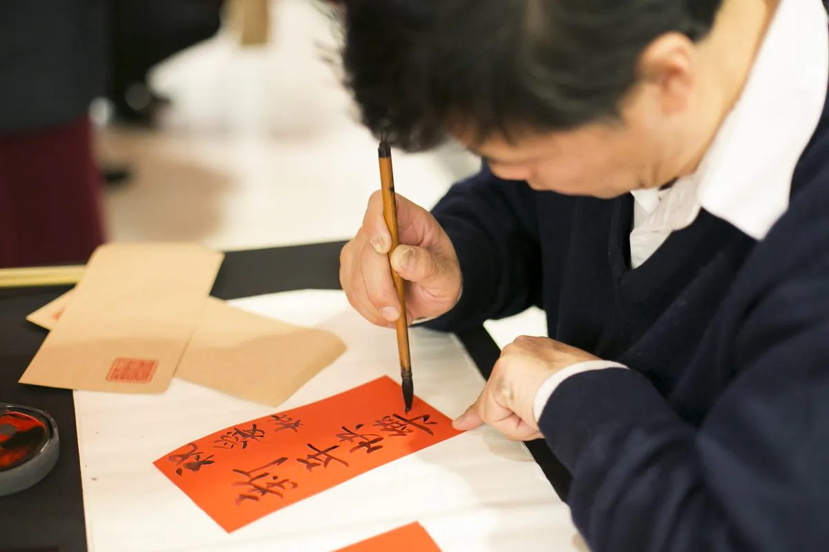 A man writes Chinese caligraphy as part of the Chinese New Year events at the Bloomingdale’s flagship store on Lexington Avenue in New York City on Feb. 19. (Samira Bouaou/Epoch Times)