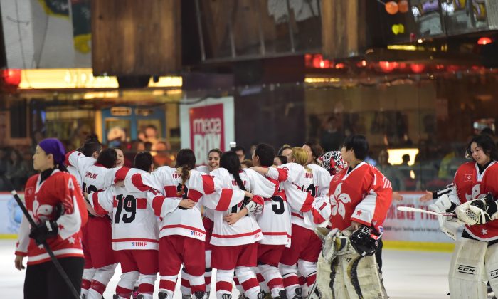 Turkey celebrates their important win against Hong Kong to move them into the lead with 6-points on day-2 of the 2015 IIHF Ice Hockey Women’s World Championship Division II Group B Qualifier tournament at Mega Ice, on Thursday Feb 19, 2015. (Bill Cox/Epoch Times)