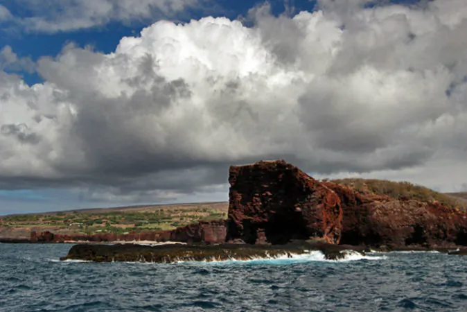 Azure ocean licks burnt orange Sweetheart Rock (Barbara Weibel, Hole in the Donut Cultural Travel)