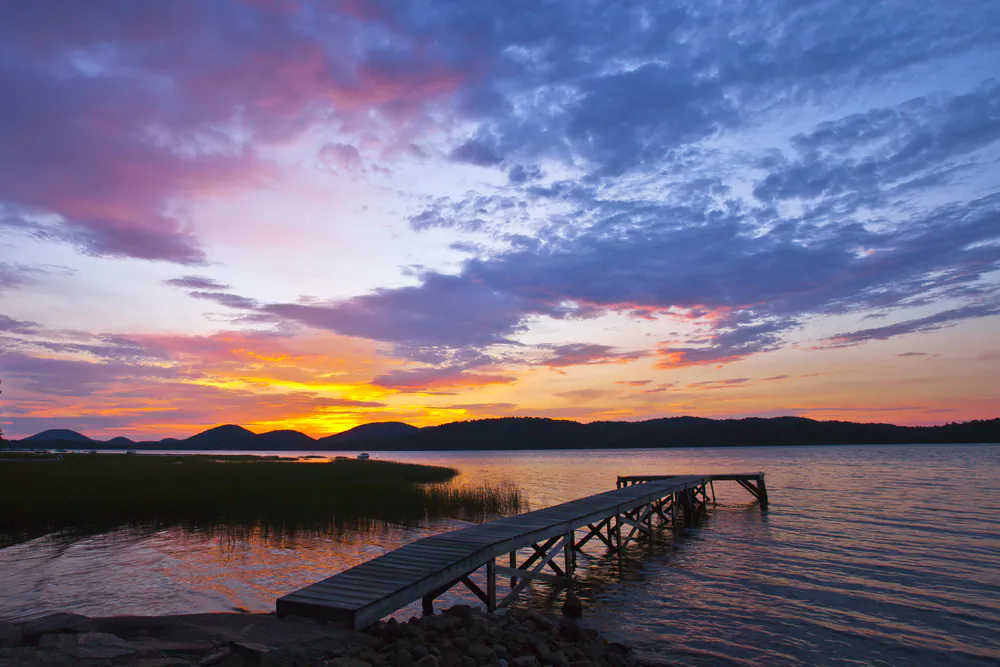Adirondack Sunrise over a quiet lake via Shutterstock*