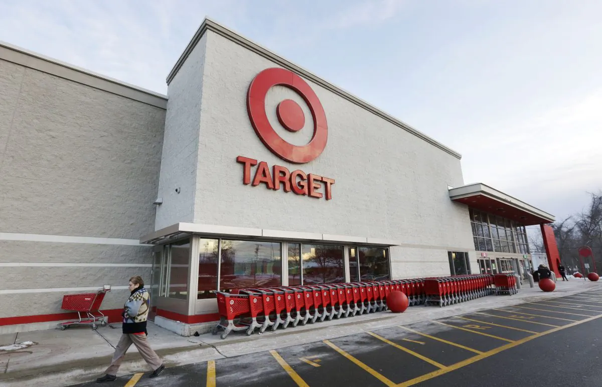In this Dec. 19, 2013, file photo, a passer-by walks near an entrance to a Target retail store in Watertown, Mass. (AP Photo/Steven Senne)