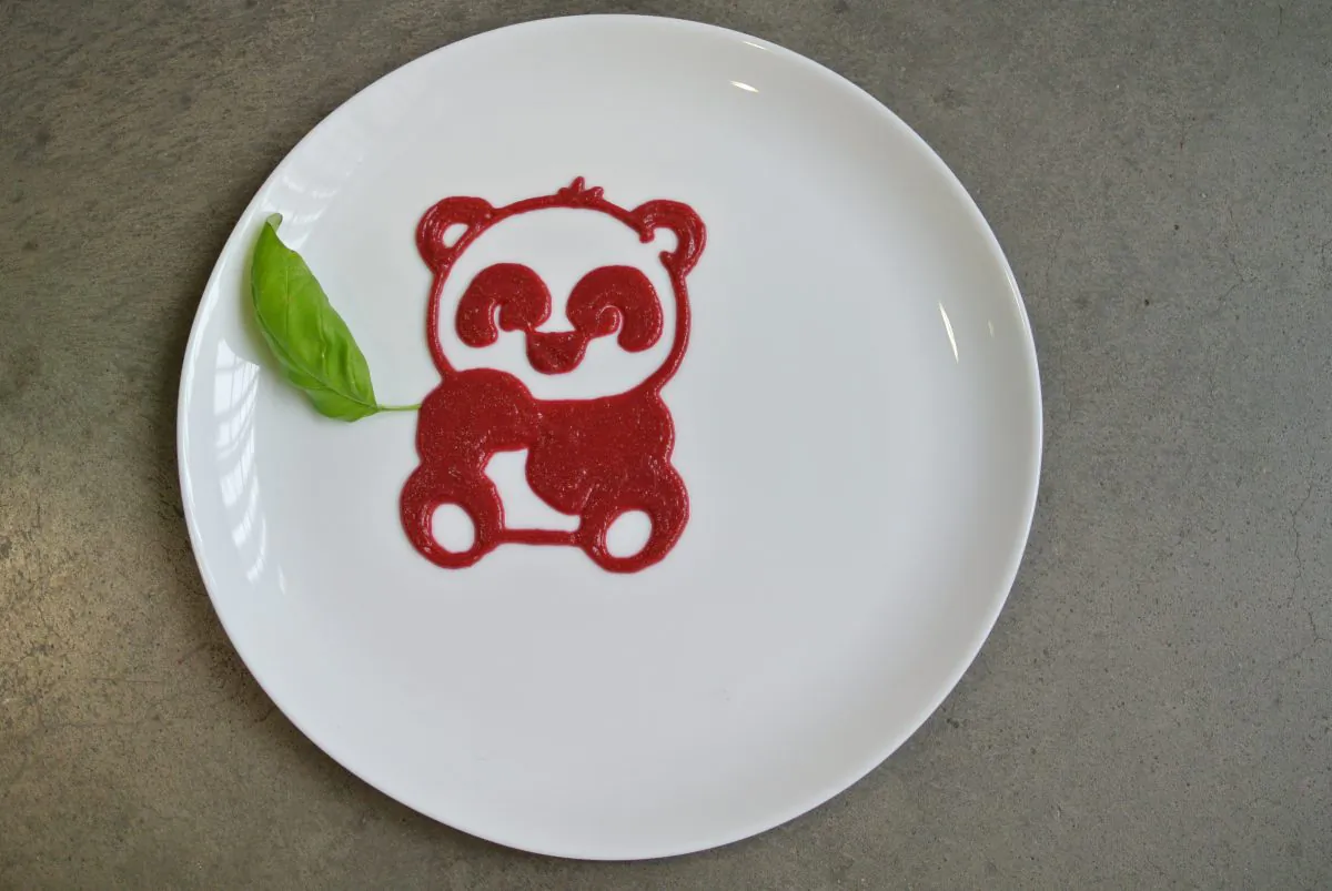 This undated photo provided by Natural Machines on Feb. 5, 2015 shows a plate decoration depicting a panda made by a food printer. Like more traditional 3-D printers, food printers work by printing out successive layers of edible material. (AP Photo/Natural Machines)