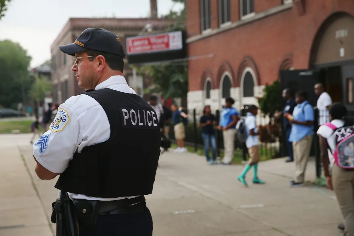 Chicago Police Sgt. Alan Lasch watches as students arrive at Laura Ward Elementary School on the Westside on August 28, 2013 in Chicago, Illinois. (Scott Olson/Getty Images)