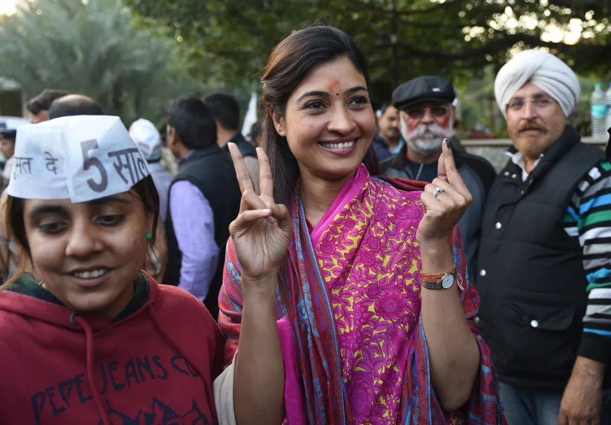 Senior leader of India's Aam Aadmi Party (AAP) Alka Lamba (C) gestures as she arrives for a meeting in New Delhi on Feb. 10, 2015. India's Narendra Modi suffered his first major election setback since becoming prime minister last May, as anti-corruption campaigner Arvind Kejriwal won a landslide victory in Delhi Territory polls. (Sajjad Hussain/AFP/Getty Images)