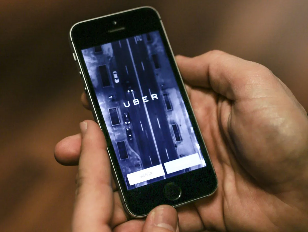 File photo: In this Feb. 10, 2015, file photo, Anthony Khoury, head of Middle East and Africa expansions for Uber, demonstrates the mobile application at a press event to celebrate the official launch of the car-hailing service in Cairo. (AP Photo/Mosa'ab Elshamy)