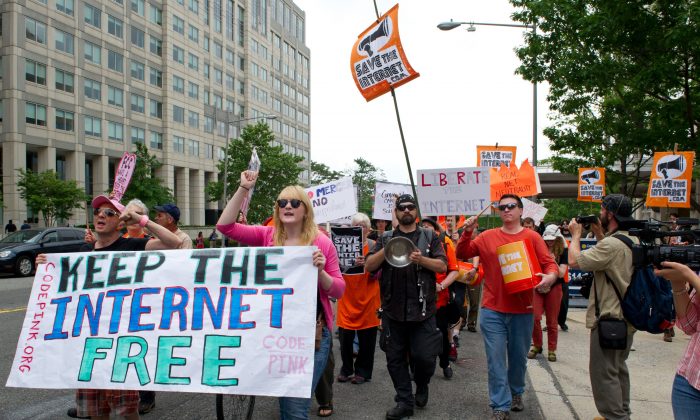 Protesters hold a rally to support 'net neutrality' and urge the Federal Communications Commission (FCC) to reject a proposal that would allow Internet service providers to create internet fast lanes, on May 15, 2014 at the FCC in Washington, DC. (KAREN BLEIER/AFP/Getty Images)