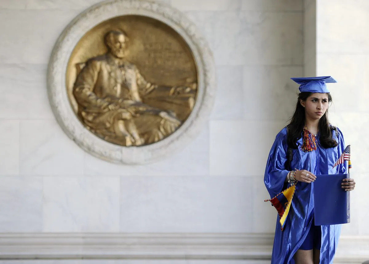A student at the University of Connecticut listens to speakers during a rally supporting financial aid for non-citizen college students at the state Capitol in Hartford, Conn., on May 20, 2014. (Jessica Hill/ AP Photo)