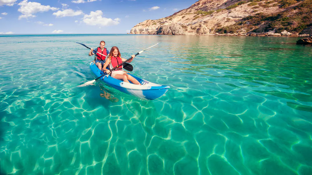 Young couple traveling by kayak via Shutterstock*