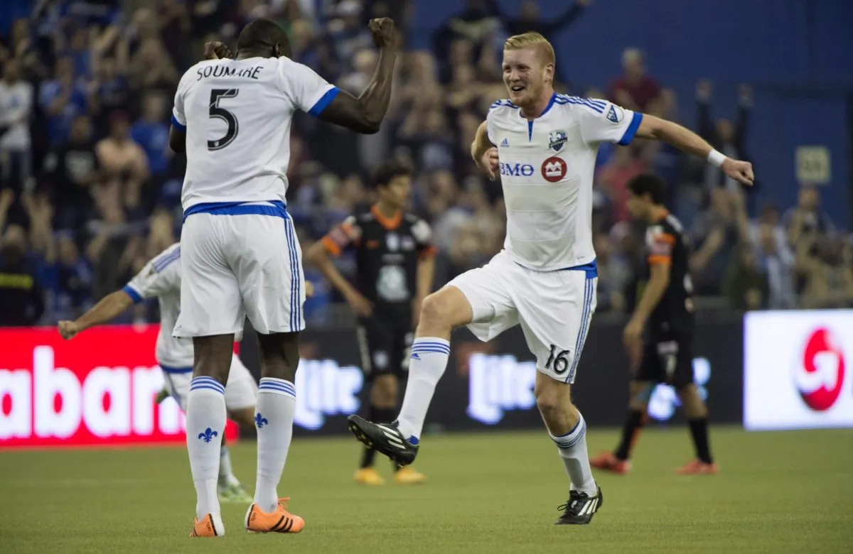 Montreal Impact’s Bakary Soumare (L) and Calum Mallace celebrate their draw against Pachuca in CONCACAF Champions League action on March 3, 2015 in Montreal. (The Canadian Press/Paul Chiasson)
