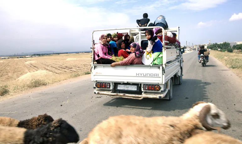 Above, refugees on the road to the Turkish border in Idlib Provence, Syria, in June 2012. (Shutterstock*)