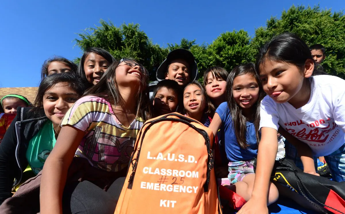 Fourth-grade schoolchildren crowd around an emergency kit backpack which each class has during an earthquake drill at Rosemont Elementary School in Los Angeles on October 17, 2013. (Frederic J. Brown/AFP/Getty Images)