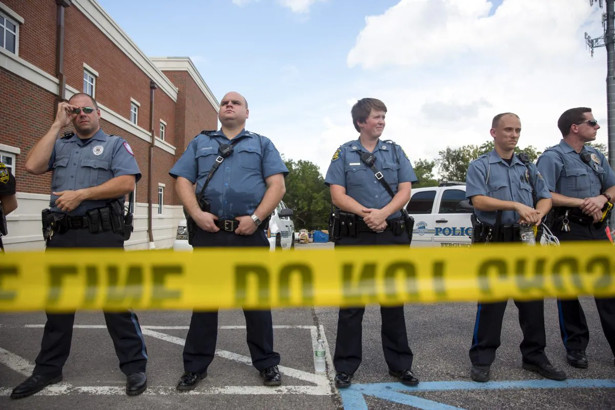 Ferguson police officers stand guard during a rally for Michael Brown outside their headquarters in Ferguson, Mo., on Aug. 30, 2014. ( Aaron P. Bernstein/Getty Images)