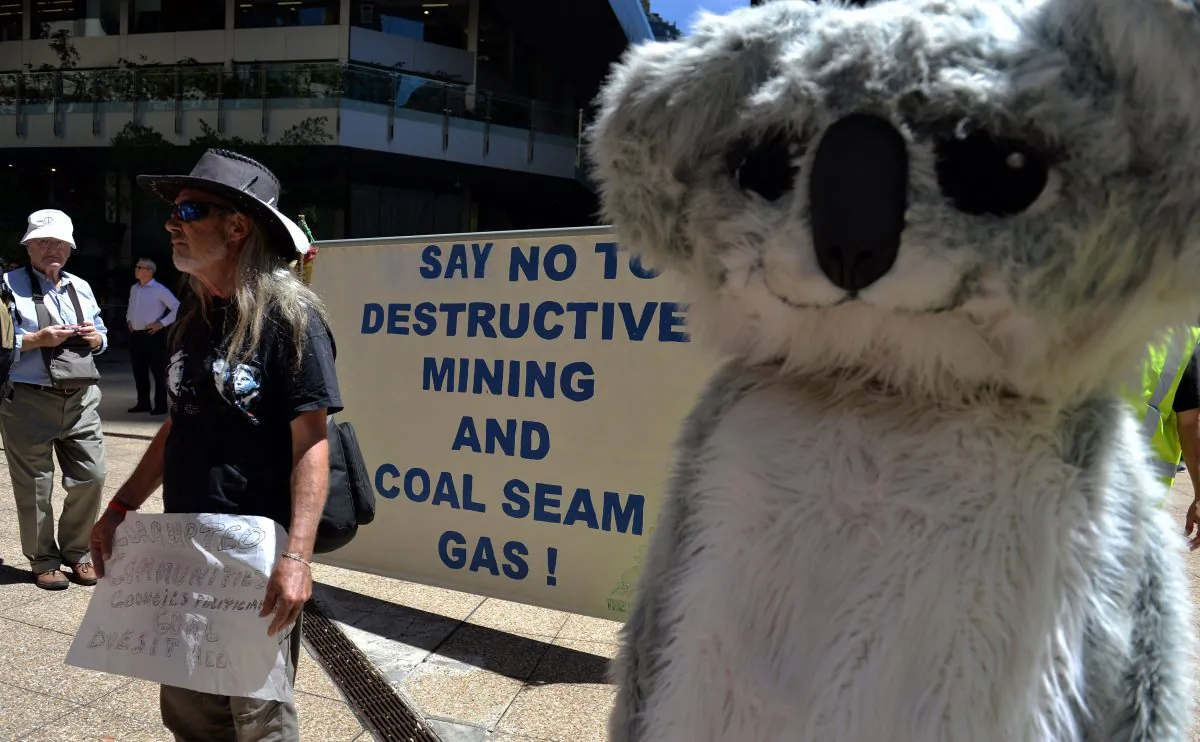 Protesters hold placards and banners during a rally against Whitehaven Coal in Sydney on February 20, 2014. (Saeed Khan/AFP/Getty Images)