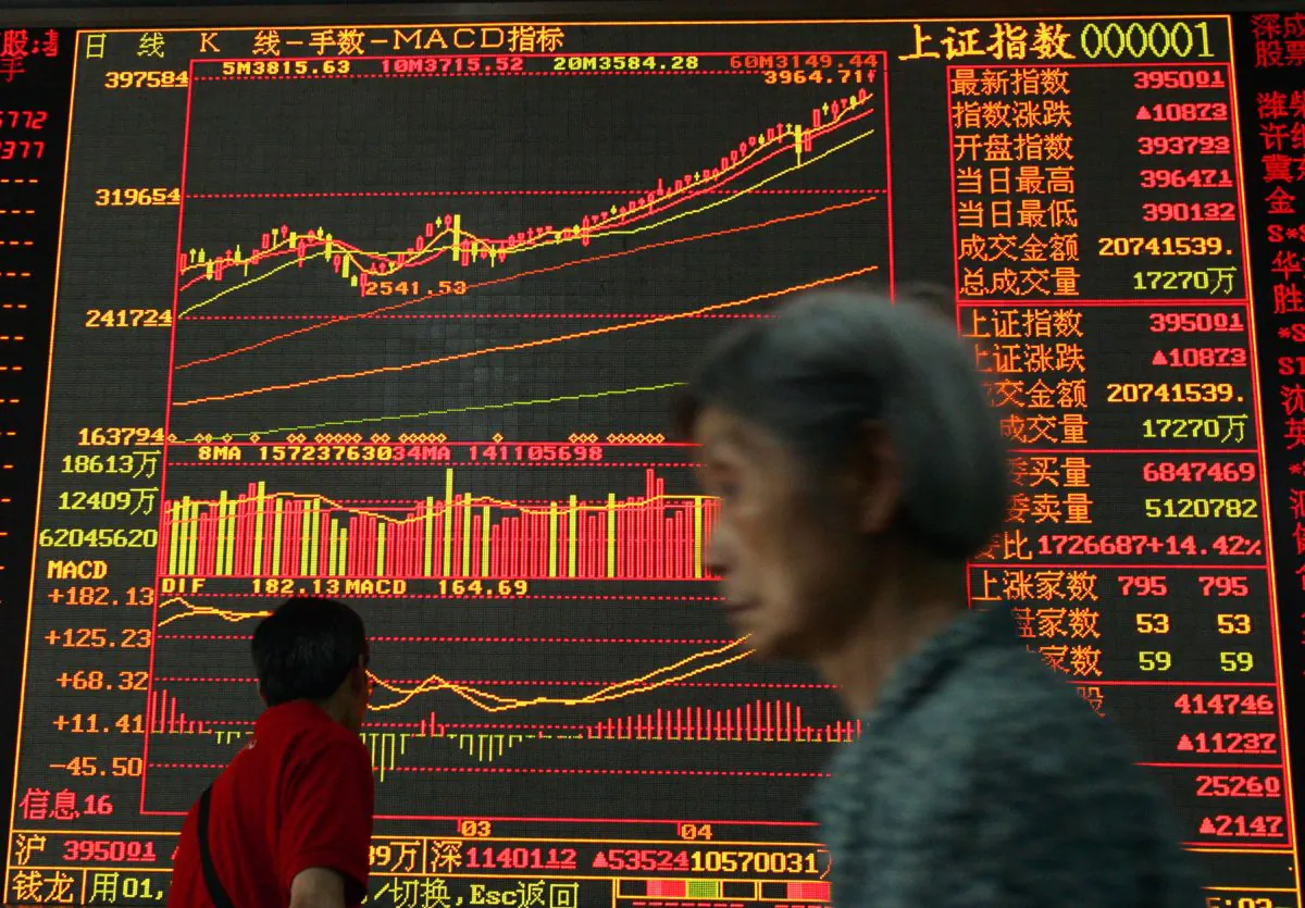 An investor walks past stock index a securities company in Wuhan, China, in this file photo. (China's stock rally will likely see intense turbulence in the near future. China Photos/Getty Images)