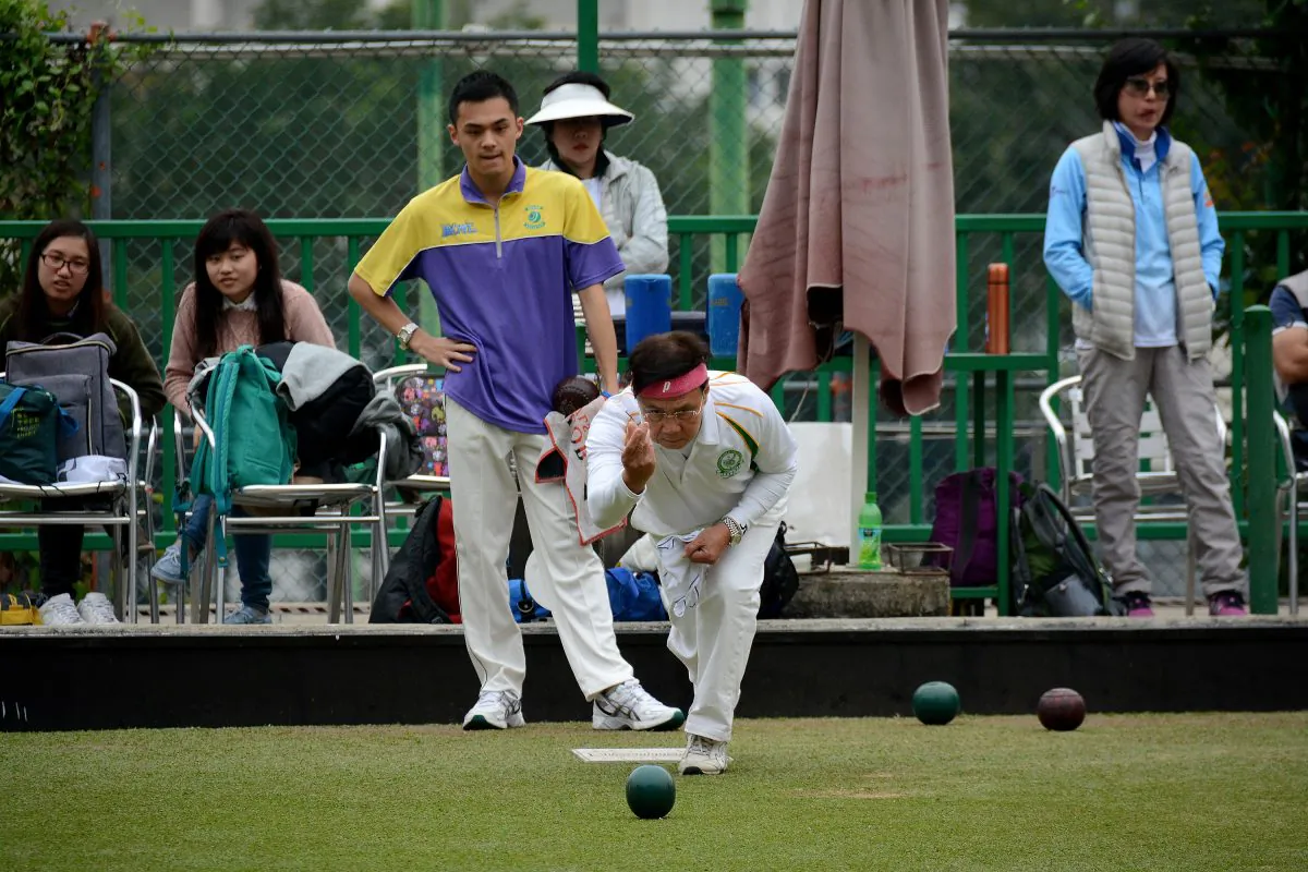 Veteran bowler David Tso (front) of Craigengower Cricket Club delivered the winning bowl at the semi-final of the National Fours against the Hong Kong Youth Team at Filipino Club on Sunday March 1. The CCC team beat the youngsters 24:16. (Stephanie Worth)