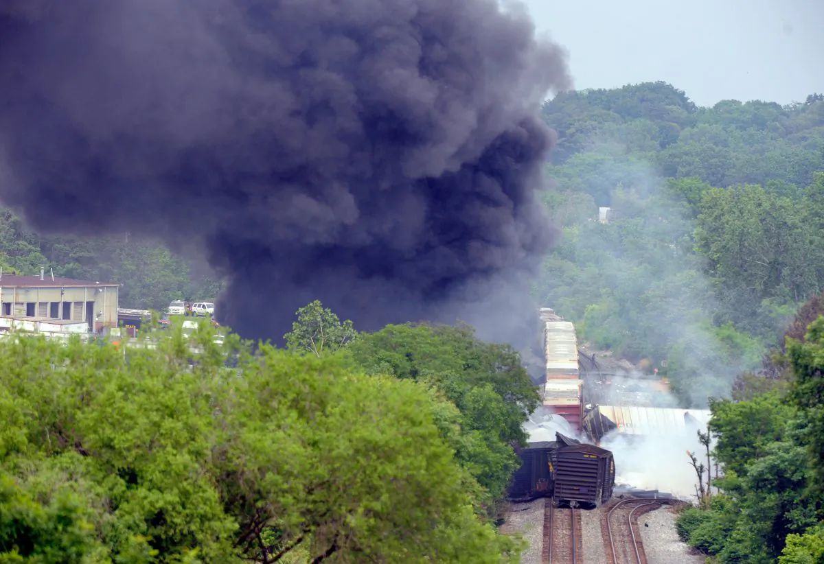 Smoke rises from a derailed train in White Marsh, Md., on May 28, 2013. The cargo train crashed into a garbage truck near Baltimore and exploded after it derailed. (Steve Ruark/Getty Images)