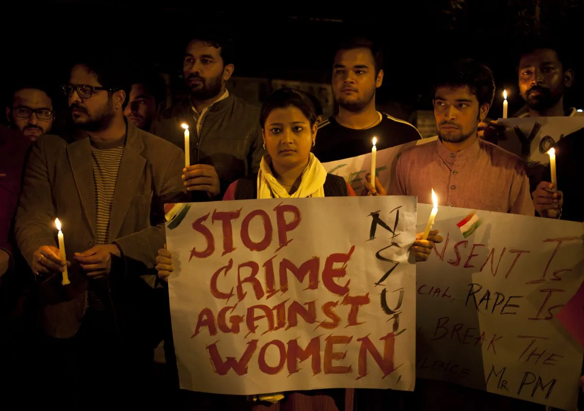 Indian youth hold candles during a protest against sexual violence in New Delhi on Feb. 9, 2015. (AP Photo/ Tsering Topgyal)