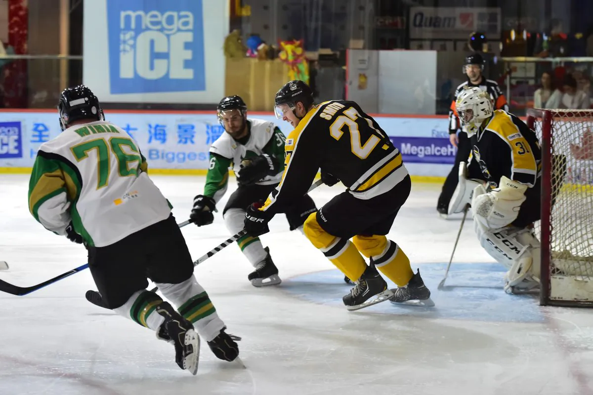 Hong Kong Tycoons’ Brad Smith back defending against an attack by Macau Aces in their 2nd best-of-three CIHL semi-final at Mega Ice on Saturday Feb 28. Tycoons edged a tight match 3-2 with an overtime goal to move into the Final to be played on March 14, 2015. (Bill Cox/Epoch Times)