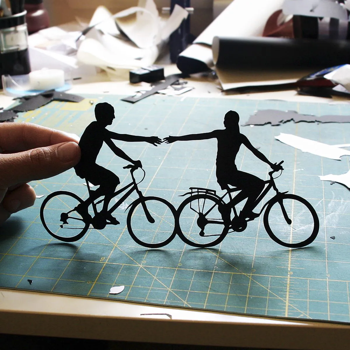 Joe Bagley 's "Holding Couple Riding Bikes" as sold on Etsy. Bagley, of Boston, painstakingly hand-cuts intricate paper art.  (AP Photo/Joe Bagley)