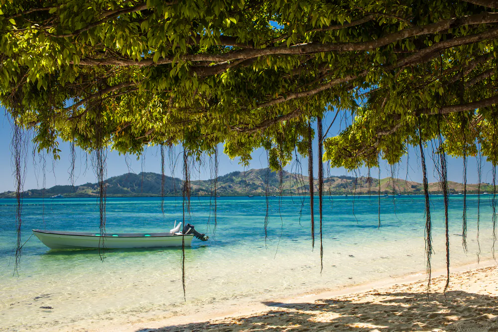 Boat and trees on a tropical beach in Fiji Islands. (Shutterstock*)