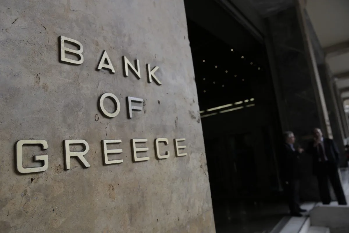 People walk past the Bank of Greece headquarters, in central Athens, on Friday, March 6, 2015 . European Central Bank head Mario Draghi said the ECB "stood ready" to once again permit Greek banks to use junk-rated Greek government bonds as collateral to get credit from the ECB. That would happen as soon as the bank assesses that Greece is likely to successfully complete a creditor review of its progress. (AP Photo/Petros Giannakouris)