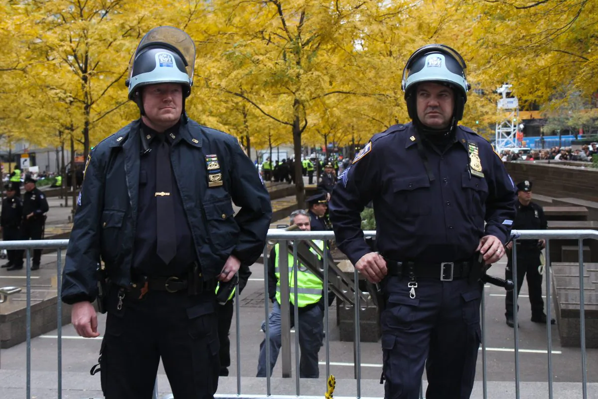 Police officers closely watch  protesters take part in Occupy Wall Street in Zuccotti Park in Manhattan, on Nov. 15, 2011. (Benjamin Chasteen/The Epoch Times)