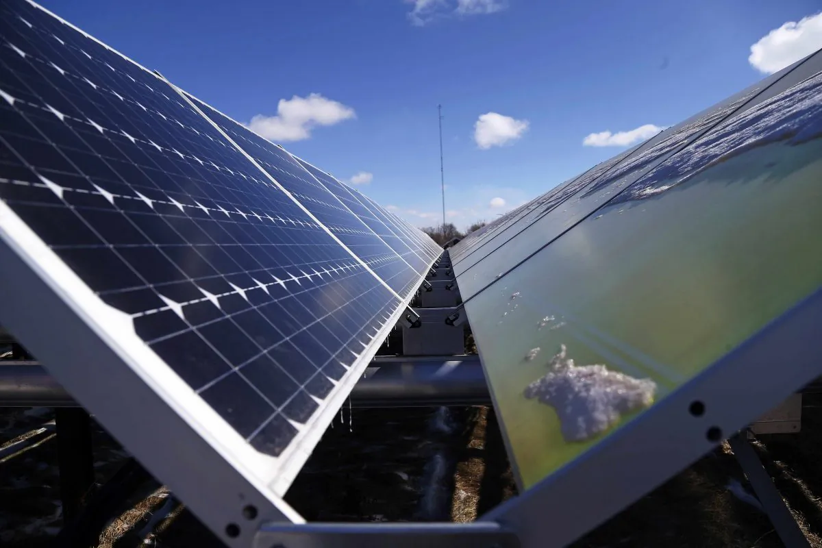 In this Feb. 26, 2015 photo, solar panels that are part of the Wright-Hennepin Cooperative Electric Association's community gardens are shown in Rockford, Minn. (AP Photo/Jim Mone)