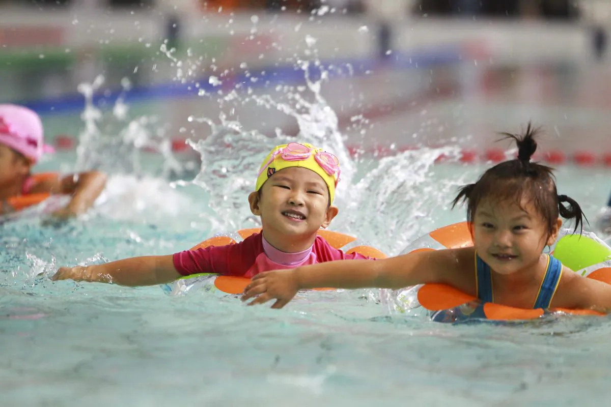A group of young Chinese children swim in Beijing on Sept. 22, 2012. Chinese Premier Li Keqiang indicated on March 5 that China may reform its controversial one-child policy. (STR/AFP/Getty Images)