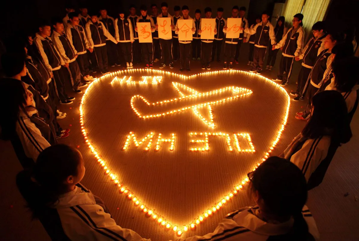 Students at Hailiang International School light candles to pray for the passengers on the missing Malaysia Airlines flight MH370 in Zhuji, in China's Zhejiang province, on March 8, 2014. (STR/AFP/Getty Images)