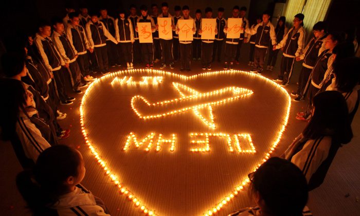 Students at Hailiang International School light candles to pray for the passengers on the missing Malaysia Airlines flight MH370 in Zhuji, in China's Zhejiang province, on March 8, 2014. (STR/AFP/Getty Images) 