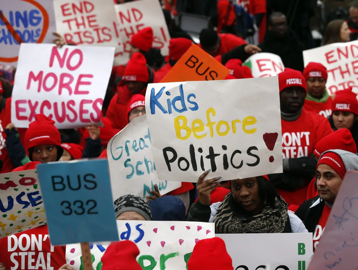 School choice advocates hold signs as they rally outside the state Capitol in Albany, N.Y., on  March 4, 2015.  (AP Photo/Mike Groll)