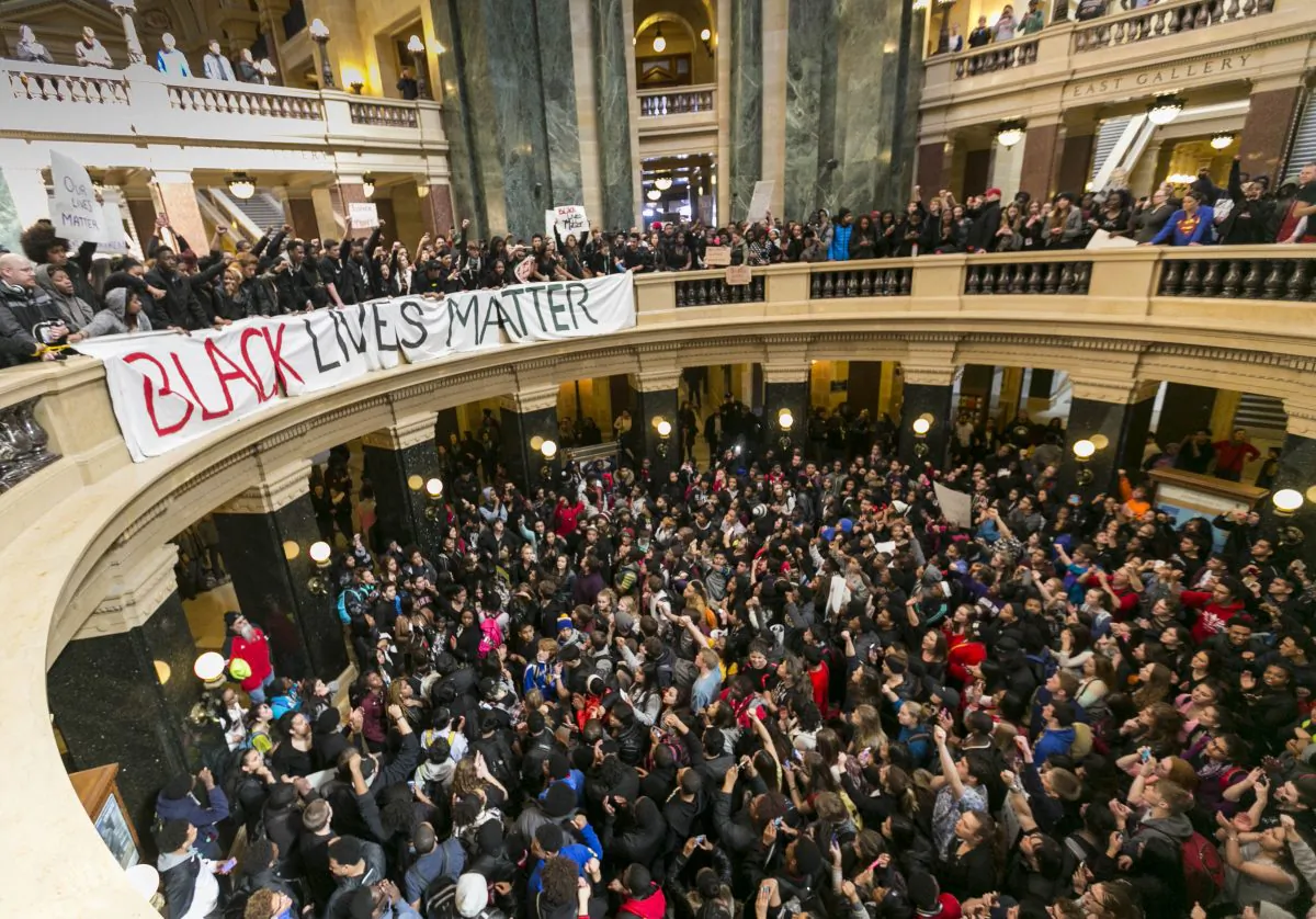 Demonstrators protest the shooting of Tony T. Robinson, at the state Capitol Monday, March 9, 2015, in Madison, Wis. Robinson, 19, was fatally shot Friday night by a police officer who forced his way into an apartment after hearing a disturbance. Police say Robinson had attacked the officer. (AP Photo/Andy Manis)