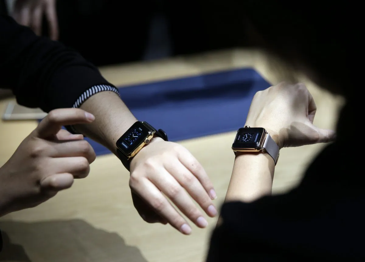 Event attendees get a look at varieties of the new Apple Watch on display in the demo room after an Apple event on Monday, March 9, 2015, in San Francisco. (AP Photo/Eric Risberg)