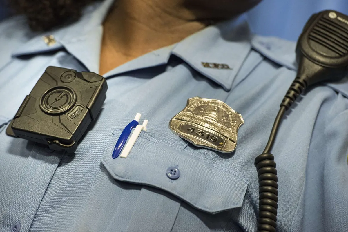 Washington DC Police Officer Debra Domino models a body camera before a press conference at City Hall Sept. 24, 2014 in Washington, DC. (Brendan Smialowski/AFP/Getty Images)