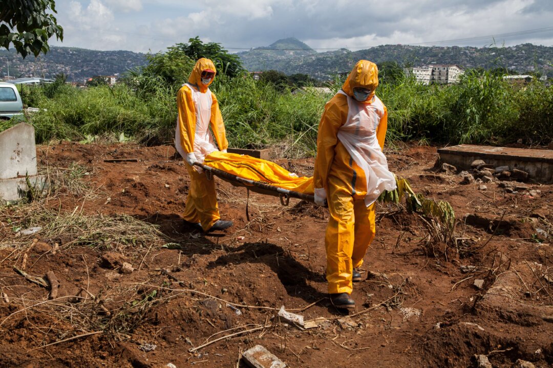 A team of funeral agents specialised in the burial of  victims of the Ebola virus. (Florian Plausheur/AFP/Getty Images)