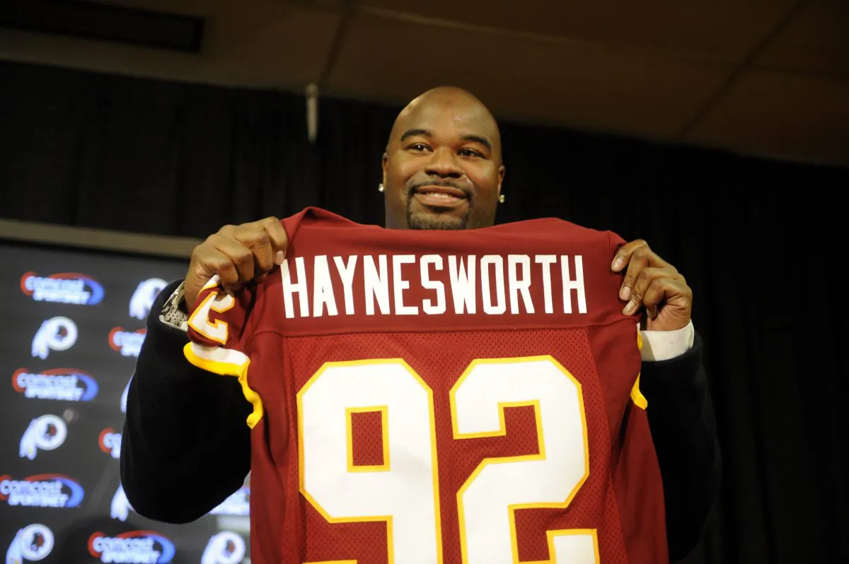 Albert Haynesworth was all smiles after signing a 7-year contract worth approximately $100 million with the Washington Redskins. The relationship would soon sour. (Mitchell Layton/Getty Images)