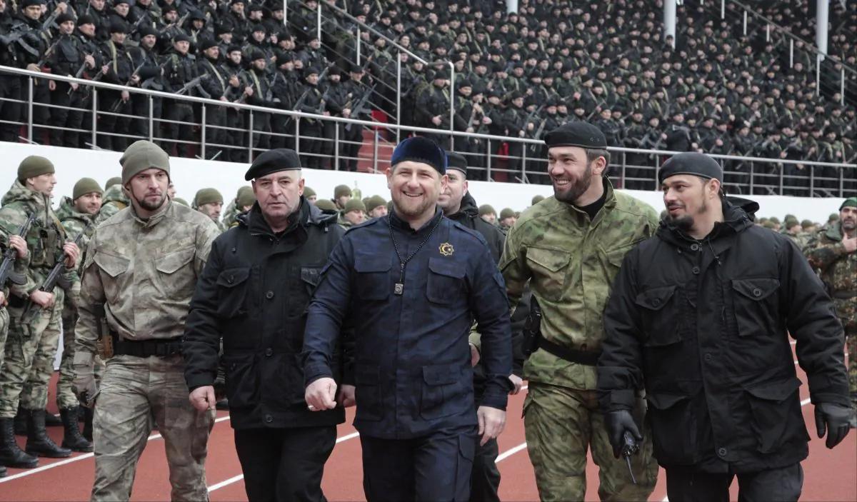 In this file photo taken on Sunday, Dec. 28, 2014, Chechnya's regional leader Ramzan Kadyrov, center, and other Chechen top commanders inspect Chechen special forces during a a rally at the Dinamo stadium in Chechen capital Grozny, Russia. Russian President Vladimir Putin bestowed a state award Monday on the leader of Chechnya, the North Caucasus strongman who hailed the suspected killer of an opposition politician as a "true patriot."Kadyrov drew criticism Sunday from government opponents after praising Zaur Dadayev, a Chechen suspect in the murder of Kremlin foe Boris Nemtsov. (AP Photo/Musa Sadulayev, file)