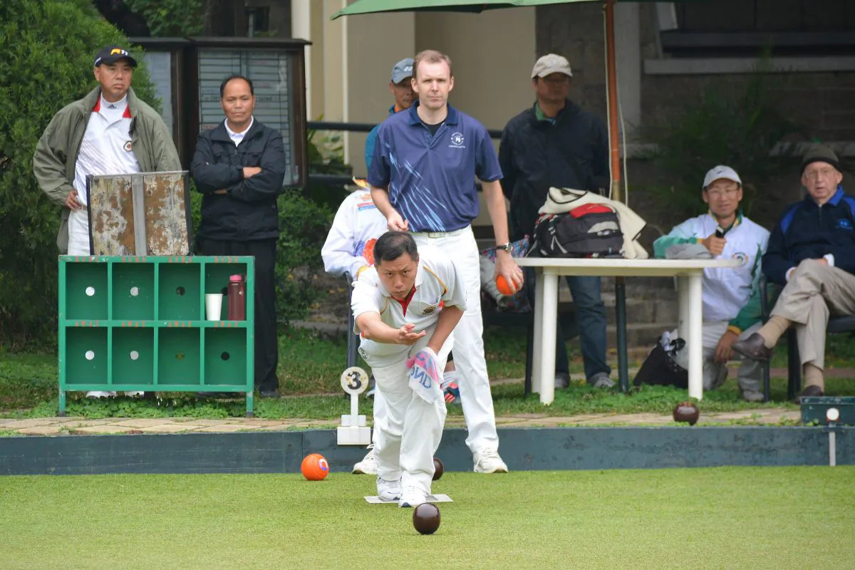 Mobin Yau (delivering) of the Hong Kong Cricket Club on his way to defeating Derek Wyllie from the Hong Kong Football Club in the final of the National Champion of Champions Singles at United Services Recreation Club last Sunday, March 8, 2015. (Stephanie Worth)