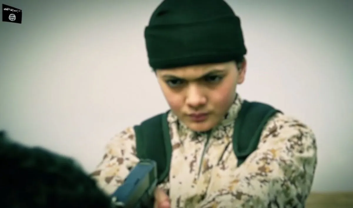 A video posted by ISIS apparently shows a child executing an alleged Israeli spy. (ISIS video screenshot taken by Epoch Times)