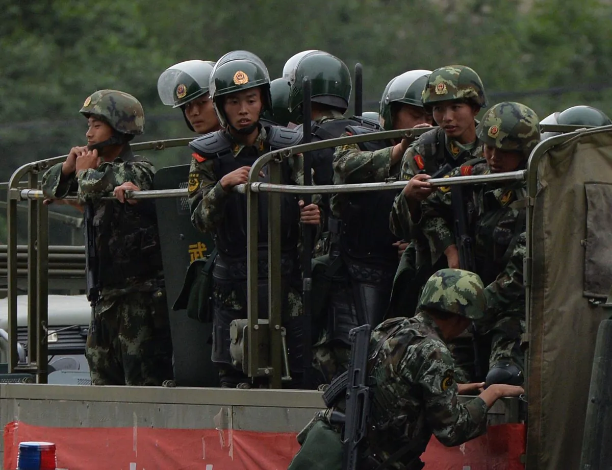 Chinese paramilitary police prepare to ride in trucks during a 'show of force' ceremony in Urumqi on June 29, 2013. The Chinese regime is revising laws to prevent military information leaks. (MARK RALSTON/AFP/Getty Images)