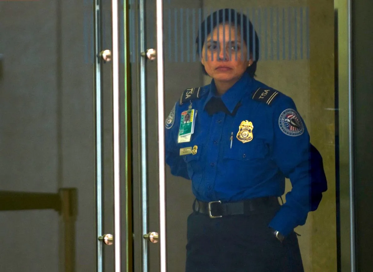 A TSA agent guards a doors at Dulles International Airport, in Chantilly, Virginia. (Paul J. Richards/AFP/Getty Images, file)