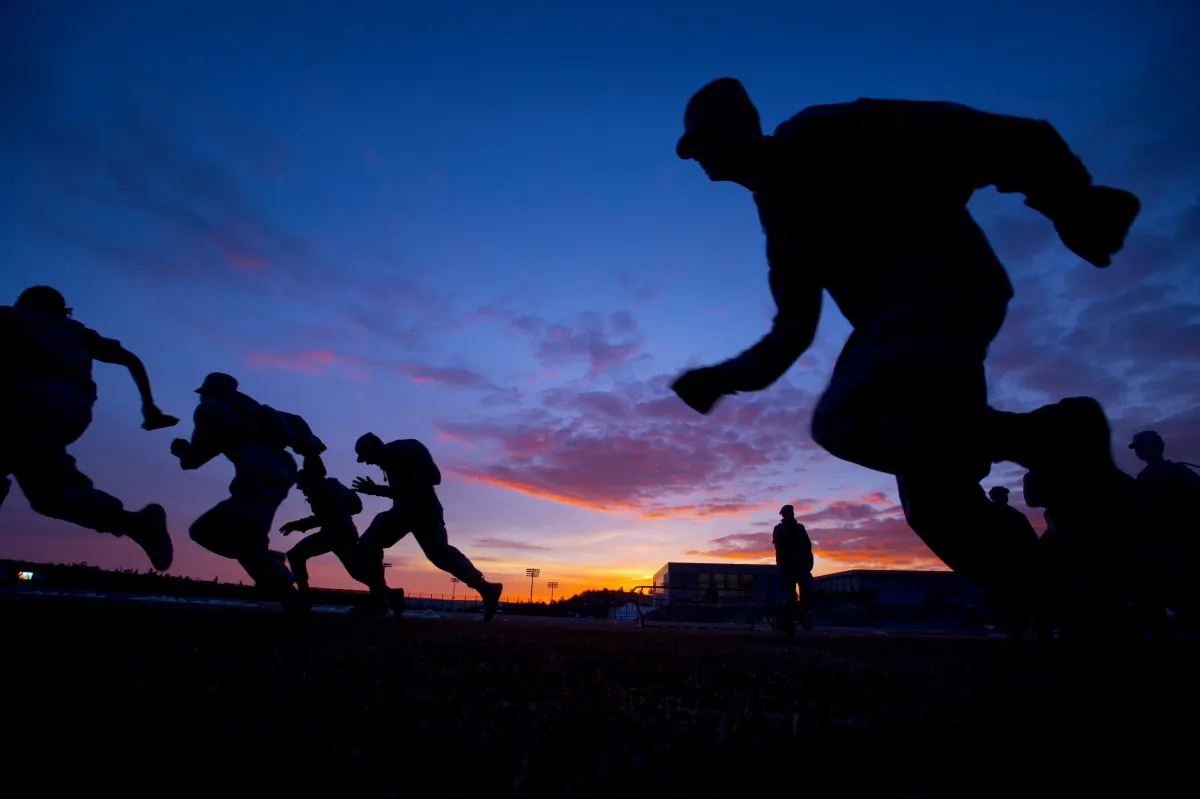 Air Force Academy freshmen run sprints at sunrise as one of the physical challenges of "Recognition" at Air Force Academy in Colorado Springs, Colo., on March 13, 2015. The annual rite moves the freshmen from "doolies" to cadets. (Mark Reis/The Gazette via AP Photo)