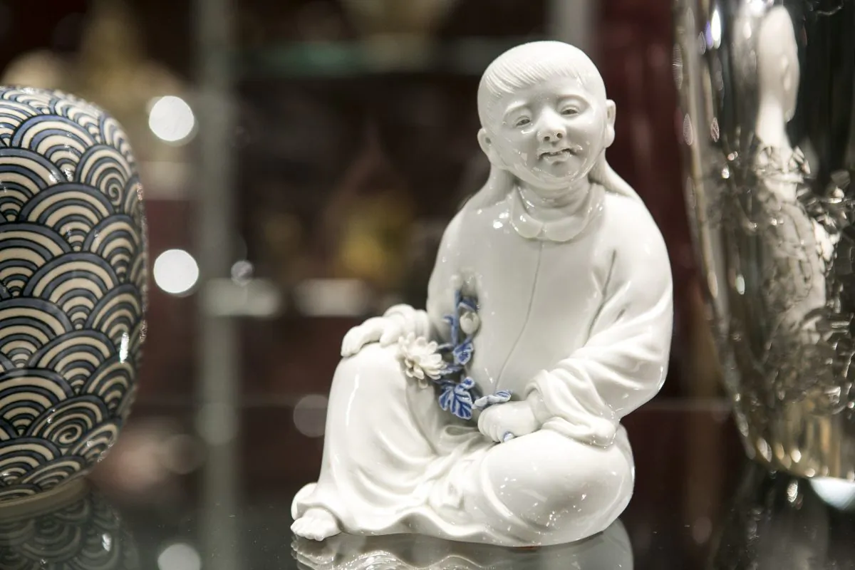 A Hirado porcelain okimono of a seated Kikujido, the beloved chrysanthemum boy from the late Edo period, Japan, at the Flying Cranes Antiques booth during the Asia Art Fair at the Bohemian National Hall in New York City, on March 12, 2015. (Samira Bouaou/Epoch Times)